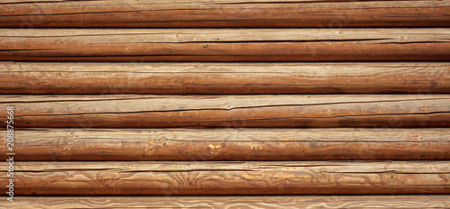 Photographie Logs on the wall with a log frame as a background