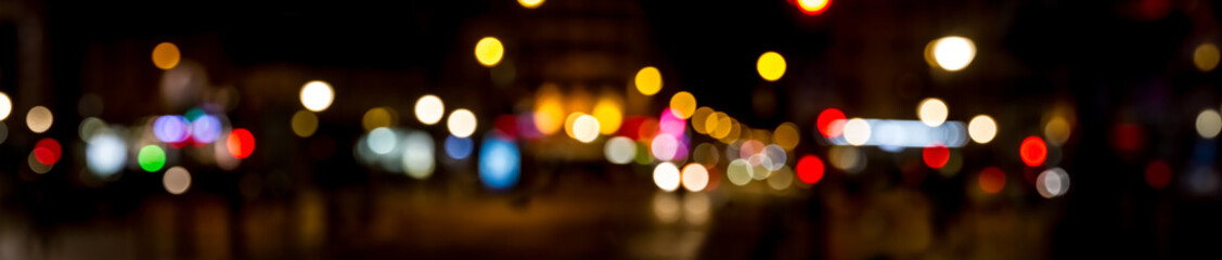 Bokeh traffic light at night in the street of a big city