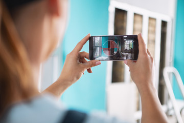 Photographing. Skilled experienced builder taking pictures while renovating a house