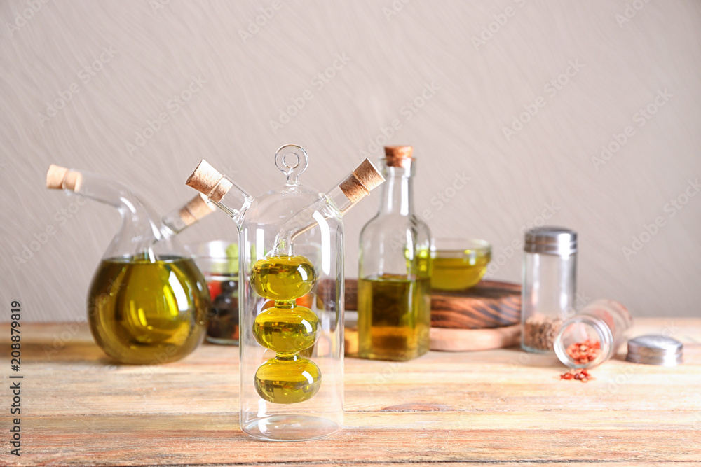 Beautiful composition with olive oil on table against light background
