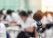 © Chinnapong - Microphone voice speaker with audiences or students in seminar classroom, lecture hall or conference meeting in educational business event for host, teacher, or coaching mentor