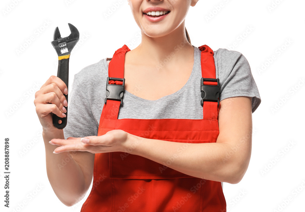 Female car mechanic with adjustable wrench on white background