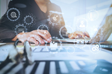 Poster - business documents on office table with laptop computer with smart phone and graph business diagram and man working in the background
