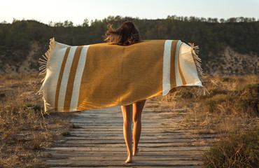 Beautiful woman wrapped in a wool towel