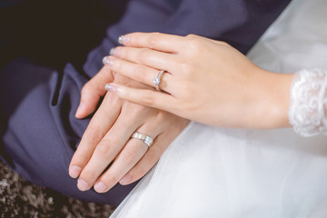 The hands of the couple touch. Both of them had a wedding ring on their left hand.