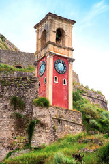 Wall Mural - beautiful landscape with a clock and bell tower in the old fortress in kerkira, corfu, greece. popul