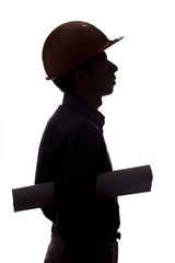 Wall Mural - silhouette of male construction engineer with building project in helmet inspecting work on white isolated background