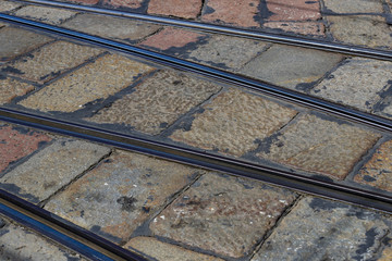 Old tram coli on the background of the old stone road