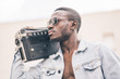 © ADDICTIVE STOCK - African man with vintage radio device.