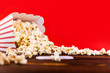 Red and White Bucket Of Popcorn With Two Red Movie Tickets