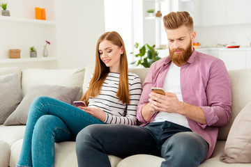 Poster - No talking two people partners communication wireless concept. Portrait of handsome serious focused guy and attractive cheerful excited lady using smartphones don't speak with each other