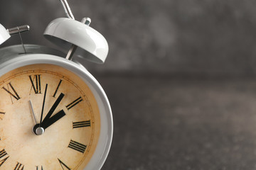Alarm clock on grey background, closeup. Time management concept