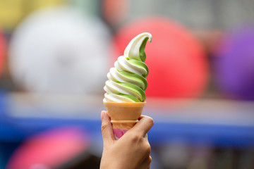 White and matcha soft cream on hand