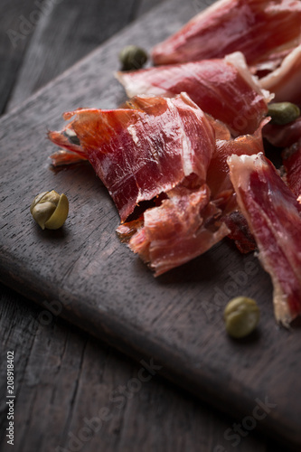 Cuadros en Lienzo Traditional Spanish Jamon Serrano ham, Prosciutto Crudo, Parma ham, Italian antipasto, served with capers