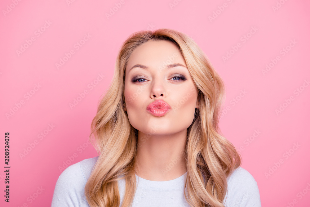 Portrait of cute lovely girl in casual outfit with modern hairdo sending blowing kiss with pout lips looking at camera  isolated on pink background. Affection feelings concept - obrazy, fototapety, plakaty 