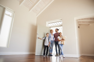 Poster - Family Opening Door And Walking In Empty Lounge Of New Home