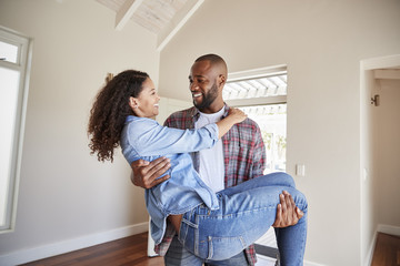 Poster - Man Carrying Woman Over Threshold Of Doorway In New Home