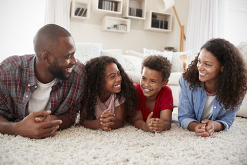 Wall Mural - Family Lying On Rug In Lounge At Home