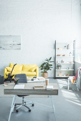 Wall Mural - modern room interior with wooden desk and cozy yellow couch