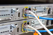 © piyaphunjun - Network switch in rack, network cables connect SFP module port in the Datacenter room, concept Communication technology