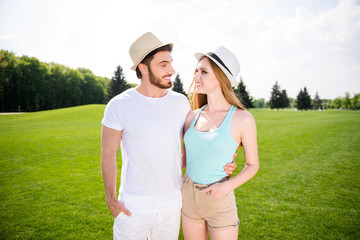 Poster - Portrait of lovely romantic couple, handsome man beautiful woman embracing looking at each other enjoying leisure free time outdoor. Tranquility rural concept