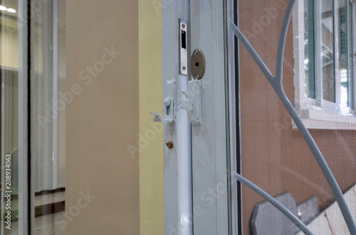 White Steel Door With Mosquito Net Protection Are Opening