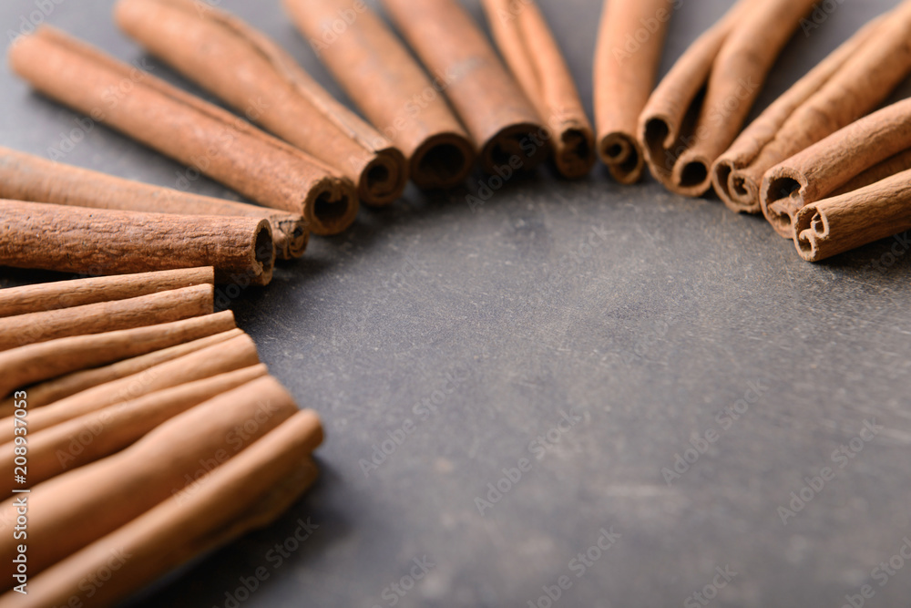 Many cinnamon sticks on grey background