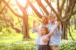 © MAGNIFIER - Happy family and daughter playing together in the garden. Soft focus concept.