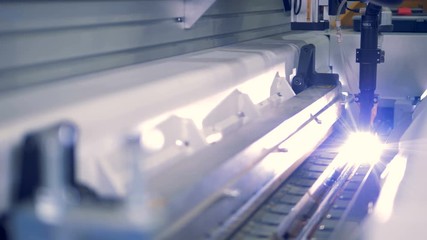 Close up of a functioning industrial machine with a switched-on light