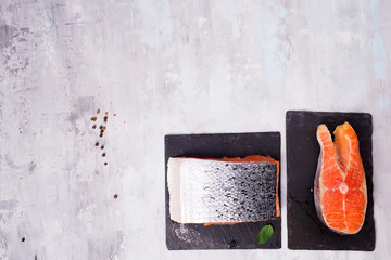 Wall Mural - pieces of salmon fillet on dark slate cutting board. Lean proteins.