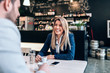 © bnenin - Smiling businesswoman having a cup of coffee with a collegue.