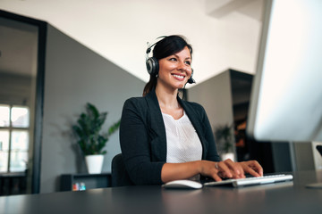 Canvas Print - Close-up image of happy woman with headset.