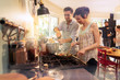© jackfrog - Mixed group of friends have fun while cooking a meal in kitchen
