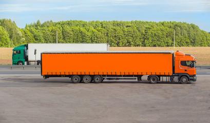 two semi-trailers running in opposite directions on the highway