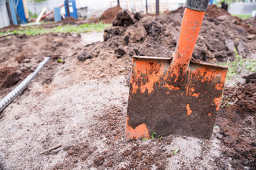 Dirty shovel dig in sand