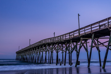 Wall Mural - morning light shining on fishing pier along the north carolina coast in holden beach