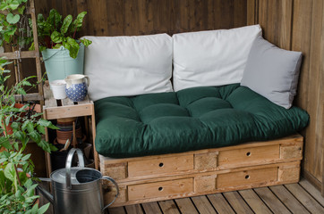 Cozy wooden pallet couch on balcony