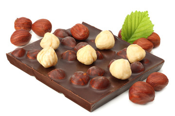 Wall Mural - chocolate with hazelnuts and leaves isolated on white background