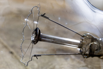 Light bulb lying on a wooden table. Lighting accessories in the old binding.