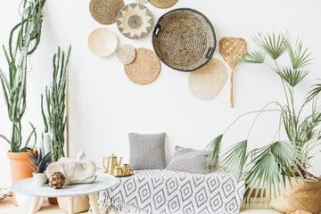 modern minimal home interior design. pillows, golden teapot, decorative straw plates, scandinavian b