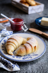 Wall Mural - Freshly baked croissants served with raspberry jam and butter