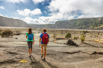 Wall Mural - Couple tourists hikers walking on Kilauea Iki crater trail hike in Big Island, Hawaii. USA summer travel vacation destination for outdoor nature adventure, american tourism.