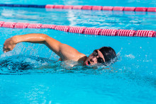 Swimmer Man Sport Training At Swimming Pool. Professional Male Athlete Doing Crawl Freestyle Stroke Technique Training Cardio At Fitness Centre.