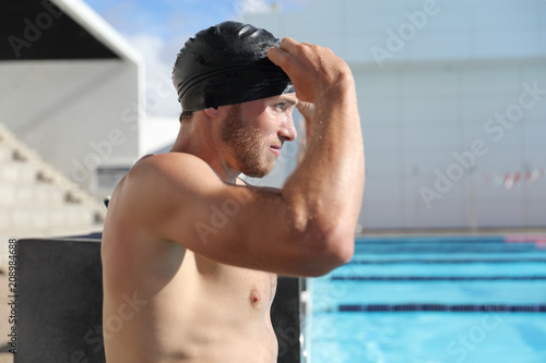 Swimming Pool Sport Male Athlete Putting On Cap And Goggles