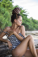 Dreamy Woman In Swimsuit Sitting On Roots