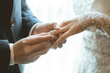 Couple wearing wedding ring at wedding day of them.