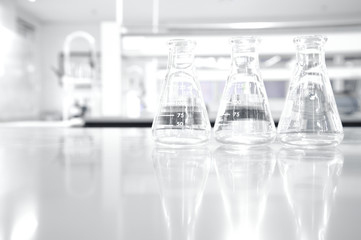 Wall Mural - three glass flask in white clean chemistry science laboratory background