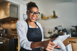 © Joshua Resnick - friendly smiling shop assistant ready to take order on pos terminal in restaurant