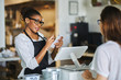 © Joshua Resnick - friendly african american waitress taking order on notepad from customer