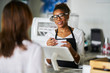 © Joshua Resnick - friendly african american waitress taking order on notepad from customer